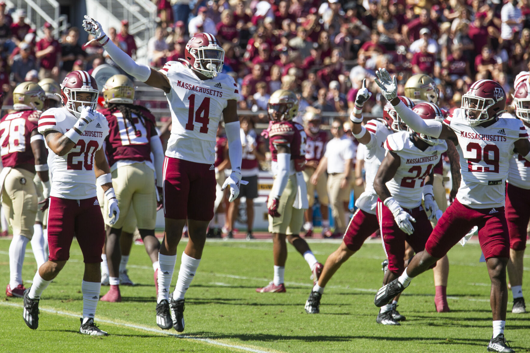 Umass football players on field